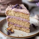 : London Fog cake slice with lavender cream cheese frosting on ceramic plate