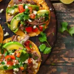 Plated Mexican Tostadas de Carne Asada with cilantro and lime
