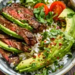 Top view of cilantro lime steak bowl with grilled steak and avocado
