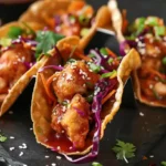 Crispy chicken wonton tacos with purple cabbage and sesame seeds