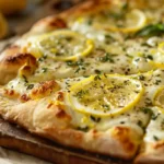 Lemon pizza with fresh herbs and mozzarella on crispy crust