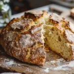 Crusty loaf of Irish Soda Bread Recipe on a wooden board
