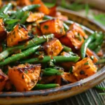 Sweet Potato and Green Bean Tray Bake served with herbs