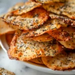 Baked cottage cheese chips with crispy edges and poppy seeds