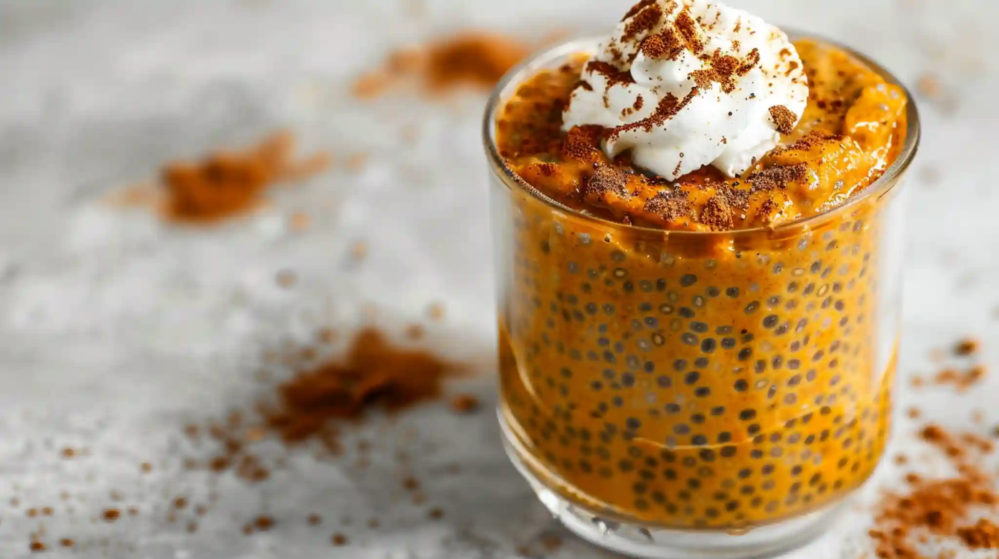 Creamy pumpkin chia pudding served with whipped topping and cinnamon