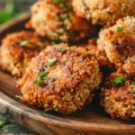 Crispy golden Crunchy Quinoa Veggie Patties on a wooden plate
