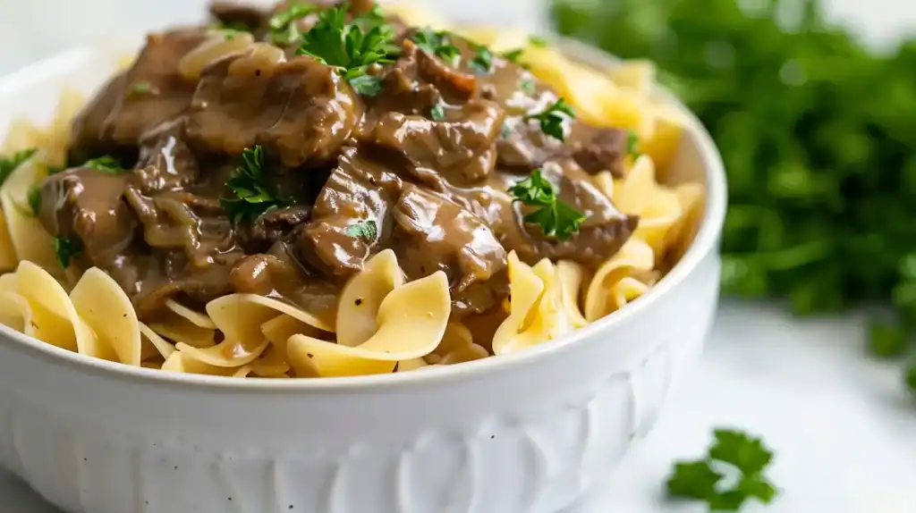 Alt text: Easy beef and noodles topped with parsley Caption: Description: