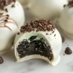 Mint Oreo truffles topped with cookie crumbs and chocolate drizzle
