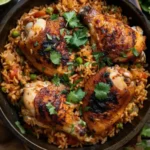 Top-down view of Caribbean chicken and rice garnished with herbs