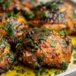 Juicy chimichurri chicken thighs garnished with fresh herbs