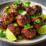 Plated spicy Mexican donkey balls topped with chili flakes and lime
